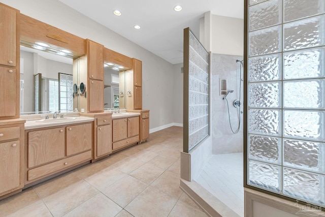 full bath featuring double vanity, walk in shower, a sink, and tile patterned floors