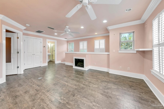 unfurnished living room featuring a fireplace, visible vents, ornamental molding, wood finished floors, and baseboards