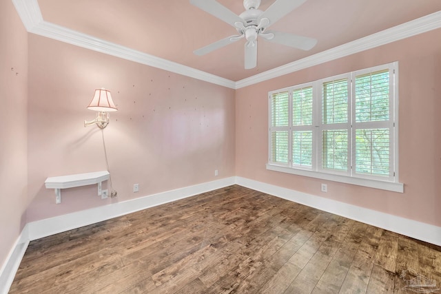 empty room featuring ornamental molding, dark wood finished floors, and baseboards