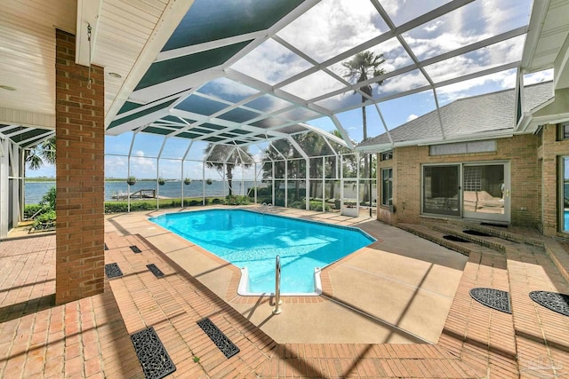 pool with glass enclosure and a patio area