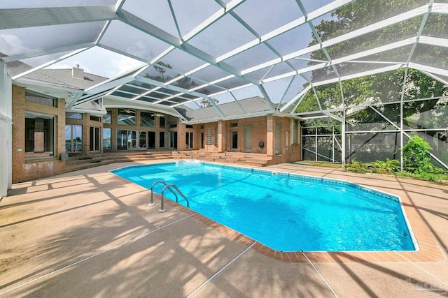 outdoor pool with a patio and glass enclosure