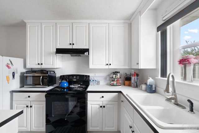 kitchen with white refrigerator, white cabinetry, sink, and electric range