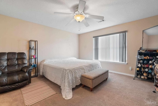 bedroom featuring a textured ceiling, ceiling fan, and carpet flooring