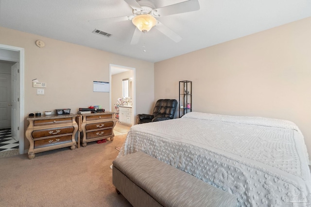 bedroom with connected bathroom, ceiling fan, and carpet