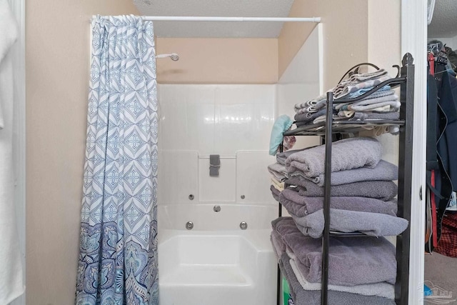 bathroom featuring a textured ceiling and shower / bath combo