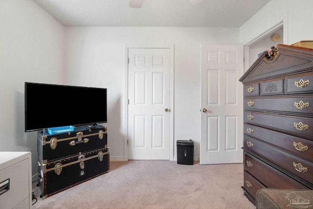 bedroom featuring ceiling fan and light carpet