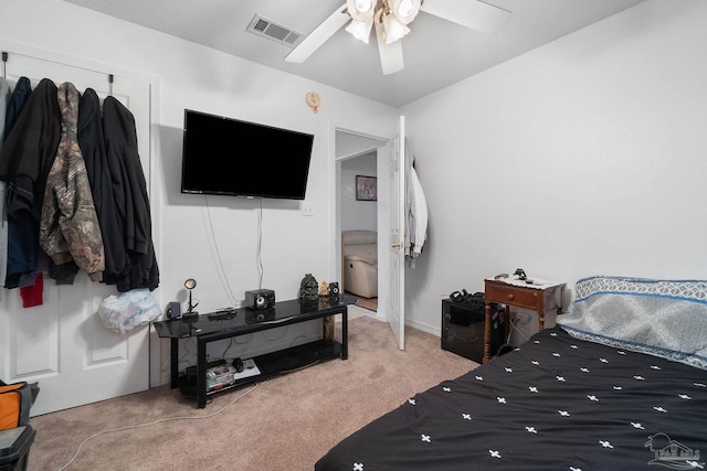 bedroom featuring light carpet and ceiling fan