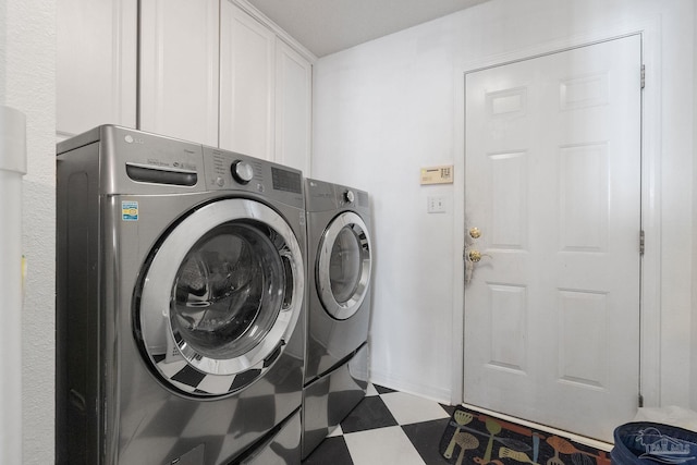 laundry room with cabinets and washer and clothes dryer