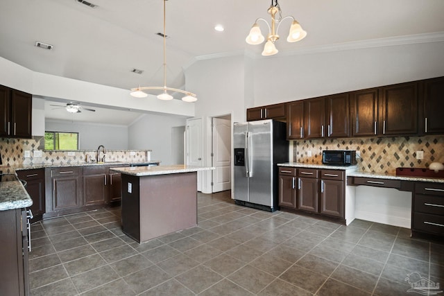 kitchen with stainless steel fridge with ice dispenser, ceiling fan with notable chandelier, a kitchen island, and hanging light fixtures