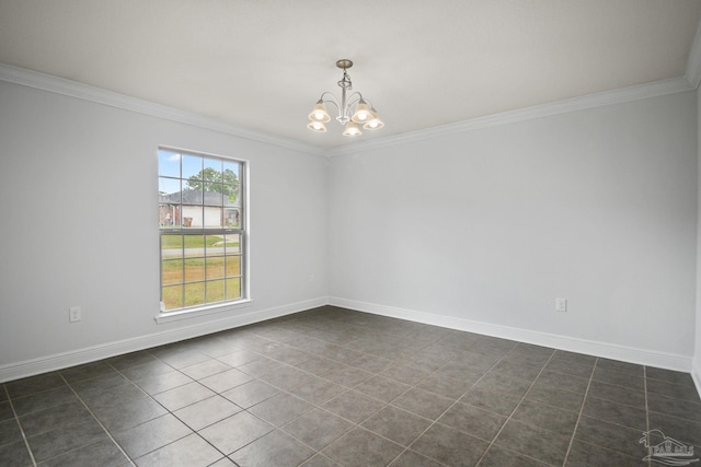 empty room with crown molding, dark tile patterned flooring, a healthy amount of sunlight, and an inviting chandelier