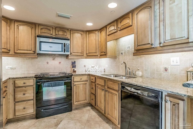 kitchen featuring light stone countertops, sink, backsplash, light tile patterned flooring, and black appliances