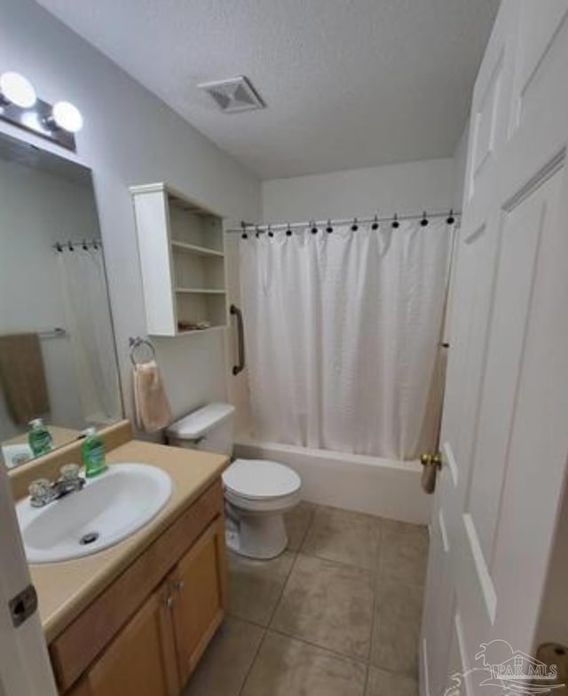 full bathroom with a textured ceiling, vanity, visible vents, tile patterned floors, and shower / bath combo with shower curtain