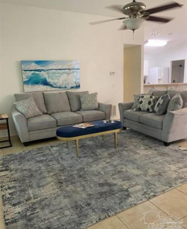 living room featuring tile patterned flooring and a ceiling fan