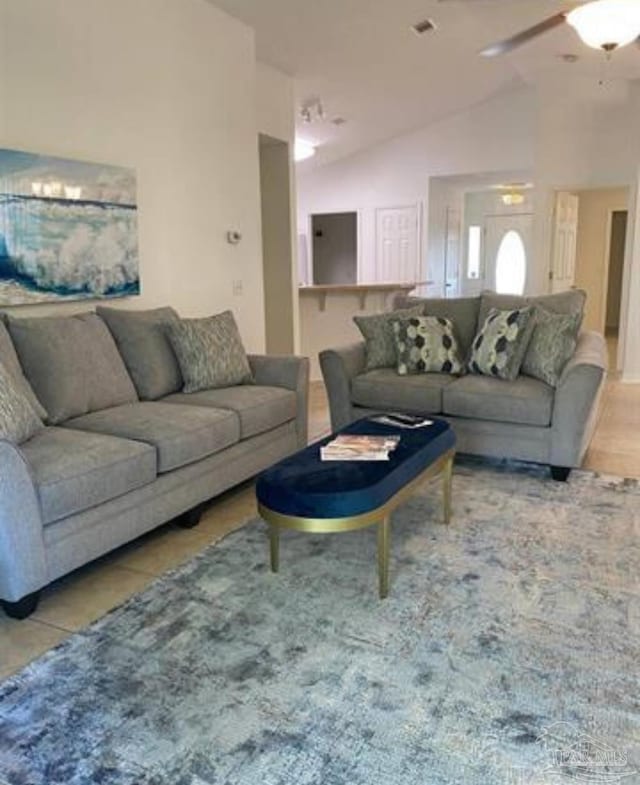 tiled living room featuring lofted ceiling