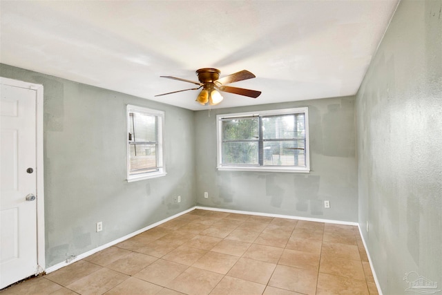 tiled empty room with ceiling fan