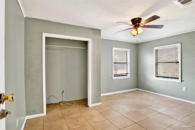 unfurnished bedroom featuring light tile patterned floors, a closet, and ceiling fan