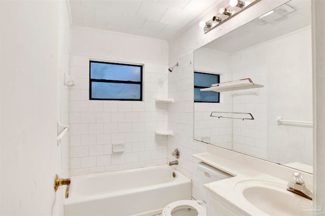 full bathroom featuring vanity, toilet, crown molding, and tiled shower / bath