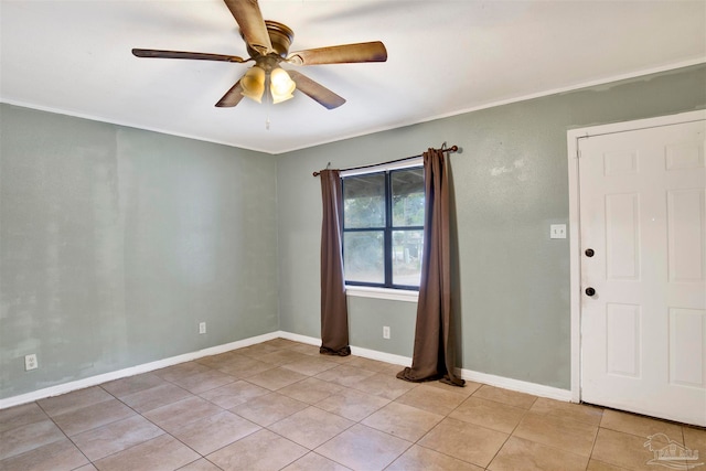 tiled empty room featuring ceiling fan