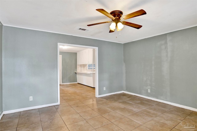 unfurnished room with ceiling fan, crown molding, and light tile patterned floors