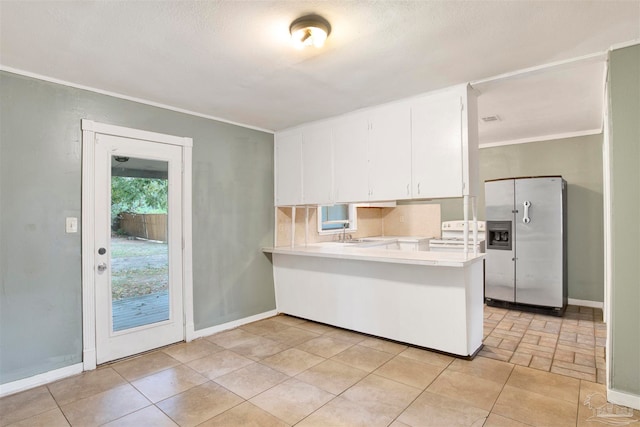 kitchen featuring backsplash, kitchen peninsula, white cabinets, ornamental molding, and stainless steel refrigerator with ice dispenser