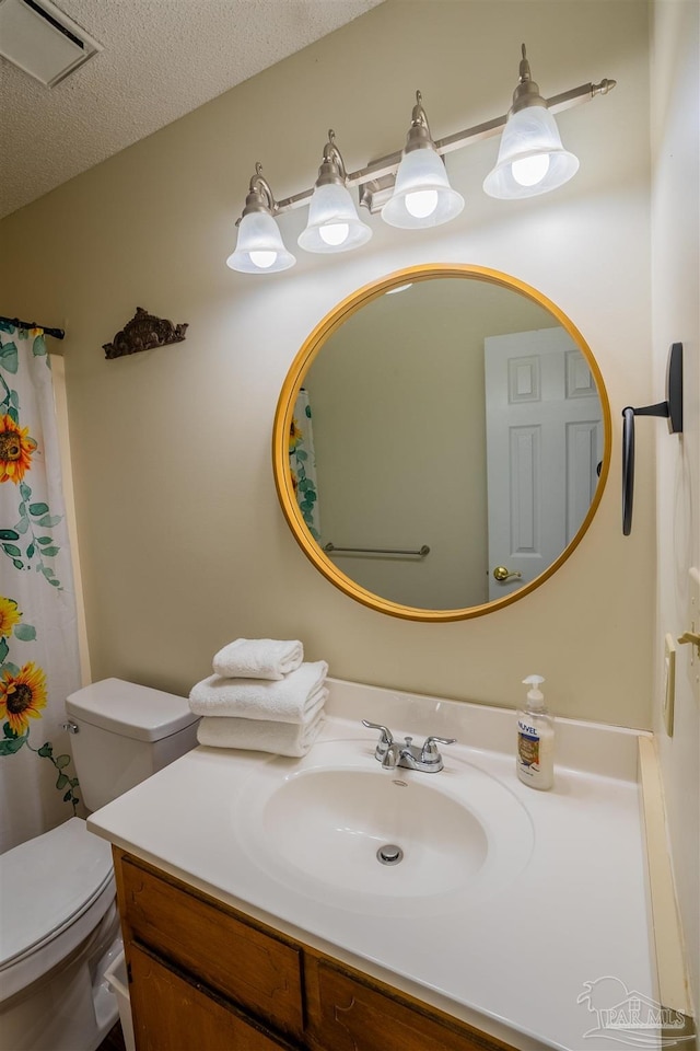 full bathroom with a textured ceiling, visible vents, vanity, and toilet