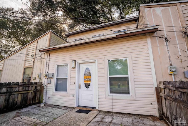 rear view of property with fence and a patio