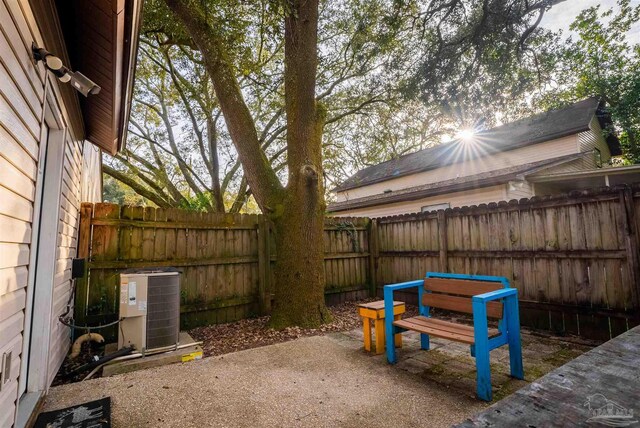 exterior space featuring central AC and a fenced backyard