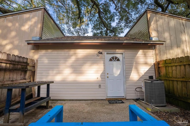 view of outdoor structure with fence and central air condition unit