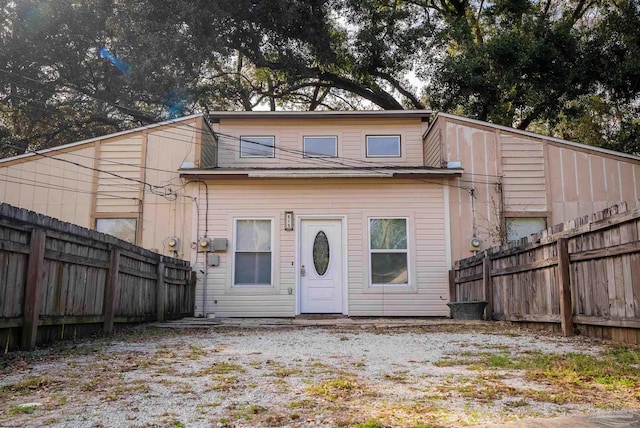 back of house with a fenced backyard