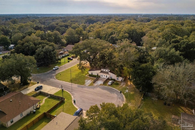 birds eye view of property featuring a residential view and a wooded view