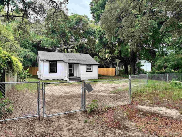 view of front of property featuring a fenced front yard and a gate