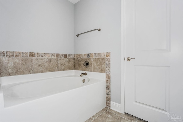 bathroom with tile patterned flooring and a bathing tub