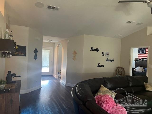 living room with vaulted ceiling, dark hardwood / wood-style floors, and ceiling fan