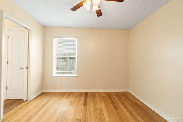 spare room featuring ceiling fan, a textured ceiling, and light hardwood / wood-style flooring