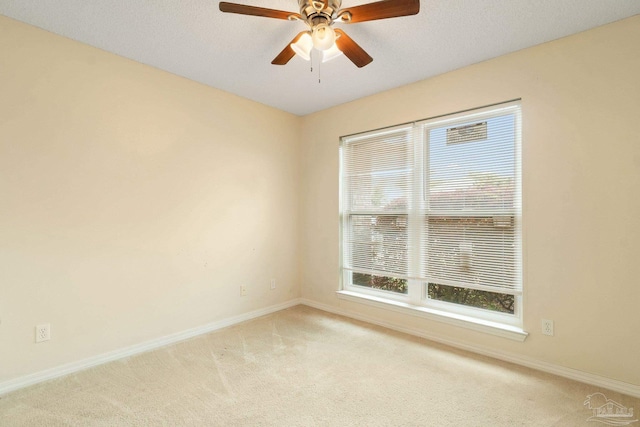 spare room with light carpet and ceiling fan