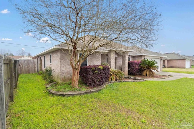 ranch-style home with a garage and a front yard