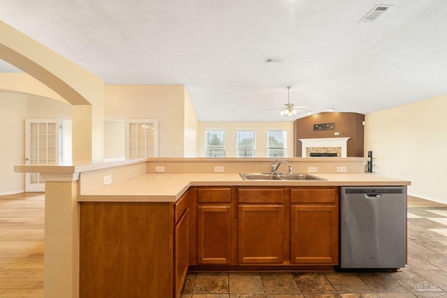 kitchen with sink, stainless steel dishwasher, a textured ceiling, and ceiling fan