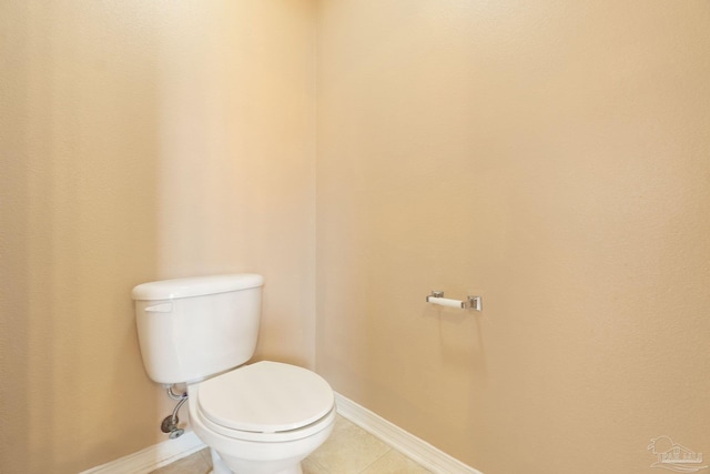 bathroom with toilet and tile patterned flooring