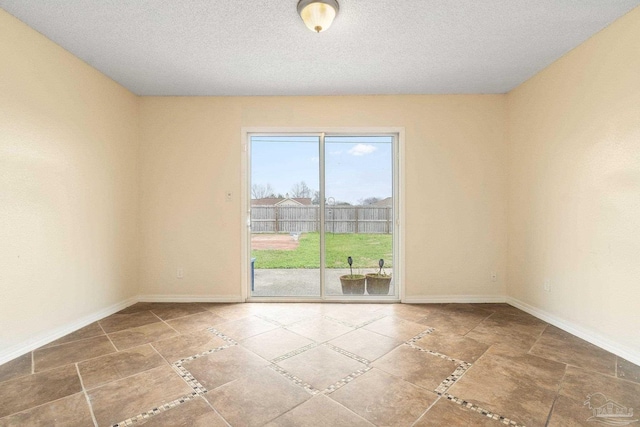 unfurnished room with a textured ceiling