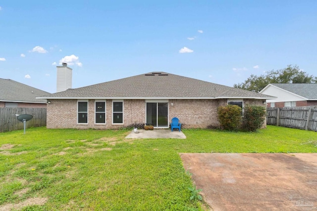 rear view of property with a patio and a yard