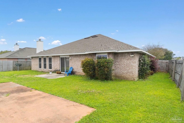 back of property featuring a yard and a patio area