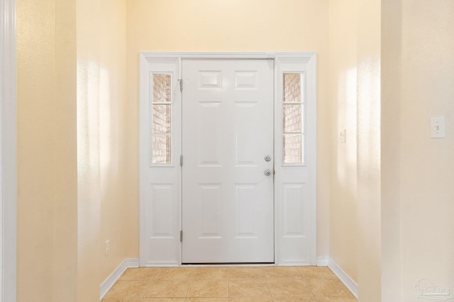 entryway with light tile patterned floors