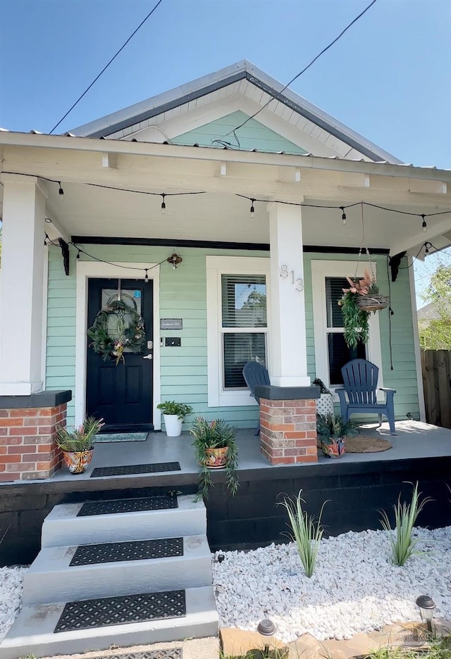 view of exterior entry with covered porch