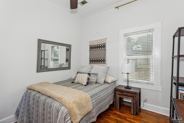 bedroom featuring dark hardwood / wood-style flooring, crown molding, and ceiling fan