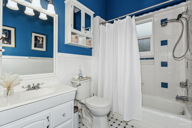 full bathroom with tile patterned floors, vanity, toilet, and shower / bath combination with curtain