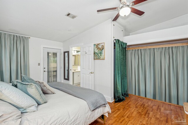 bedroom featuring ensuite bathroom, hardwood / wood-style flooring, vaulted ceiling, and ceiling fan