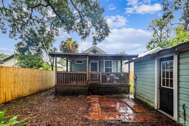 rear view of house with a deck and a patio area