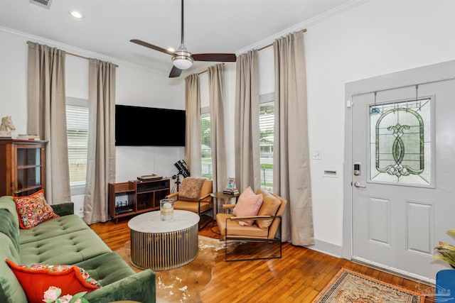 living room featuring crown molding, ceiling fan, and wood-type flooring