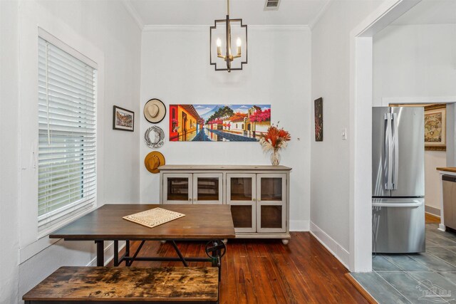 dining space with an inviting chandelier, dark hardwood / wood-style floors, and ornamental molding