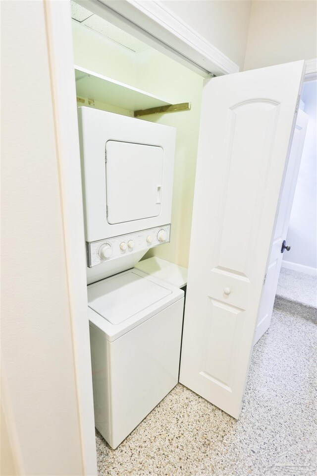 washroom featuring stacked washer and dryer